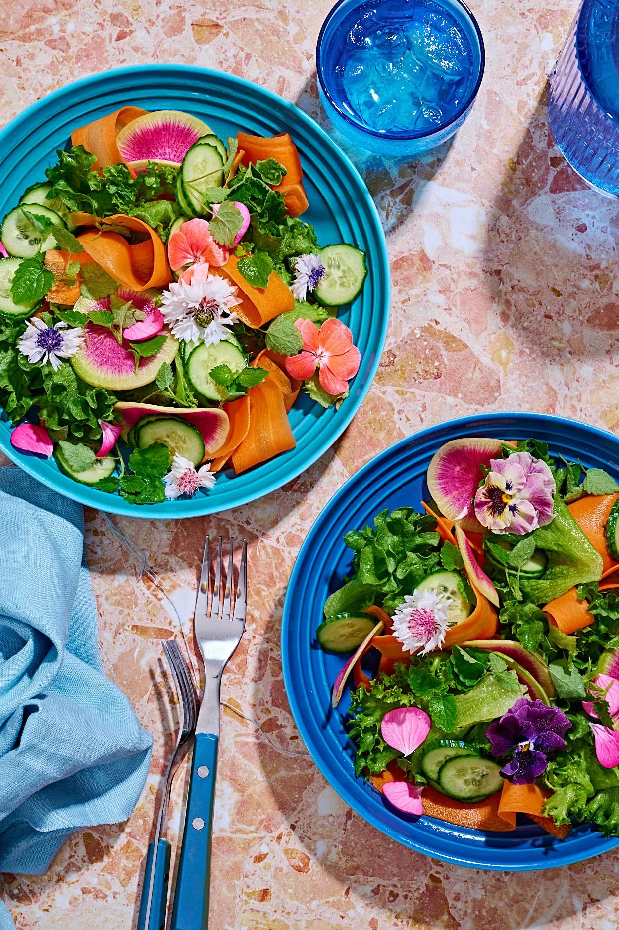  Spring salad with leafy greens, carrots, cucumber and flowers by food photographer Rachel Korinek, Toronto. 