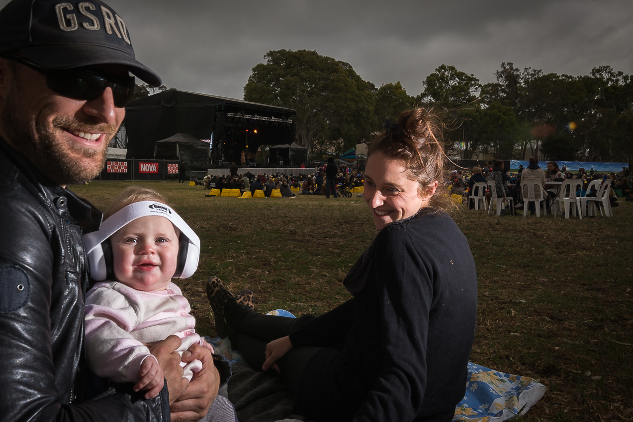 Roving style Pop- up Studio coverage at an outdoor event. Shooting with an overcast day with flay grey clouds? No problems, we create small 'sun' rays to add more interest on this image. ps the little bub did helped