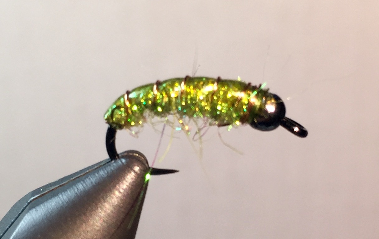 Step 5: Wrap the copper wire the opposite direction as you did the dubbing, making sure the glass stays on top of the fly. At the Bead, make two or there extra loops around and then whip finish to secure with thread