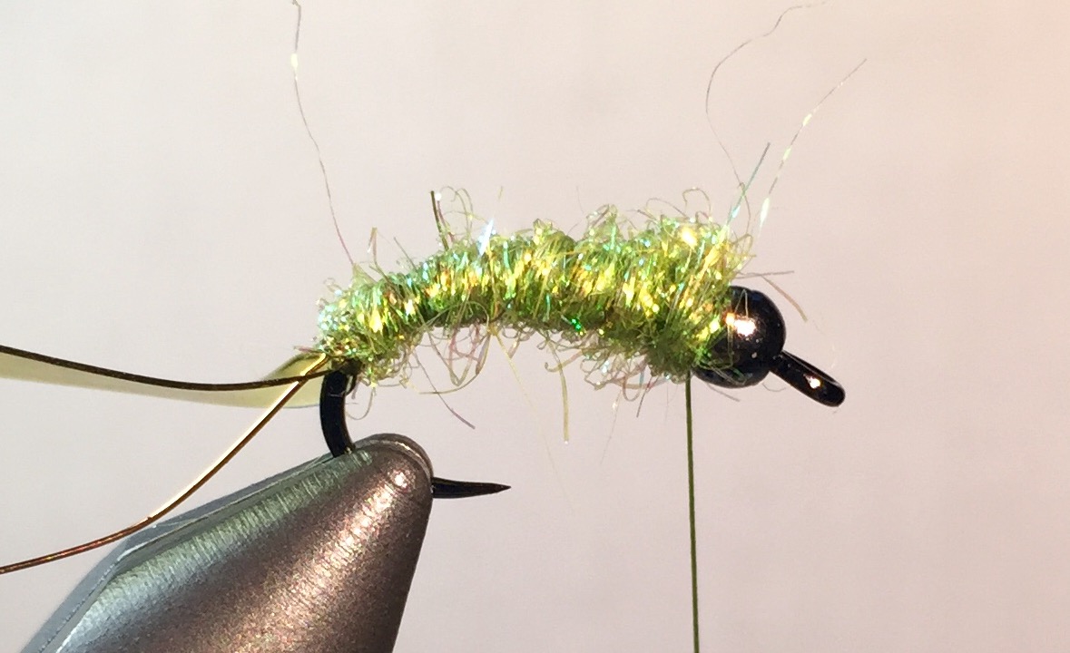 Step 3: Apply Orvis Hare’ E Ice dubbing to the thread for approximately 4 to 5 inches (you can also use a dubbling loop in so inclined). Use your fingers to “mat’ the dubbing to the thread by briskly twisting. Wrap dubbing up to the bead. The dubbing should be bushy.