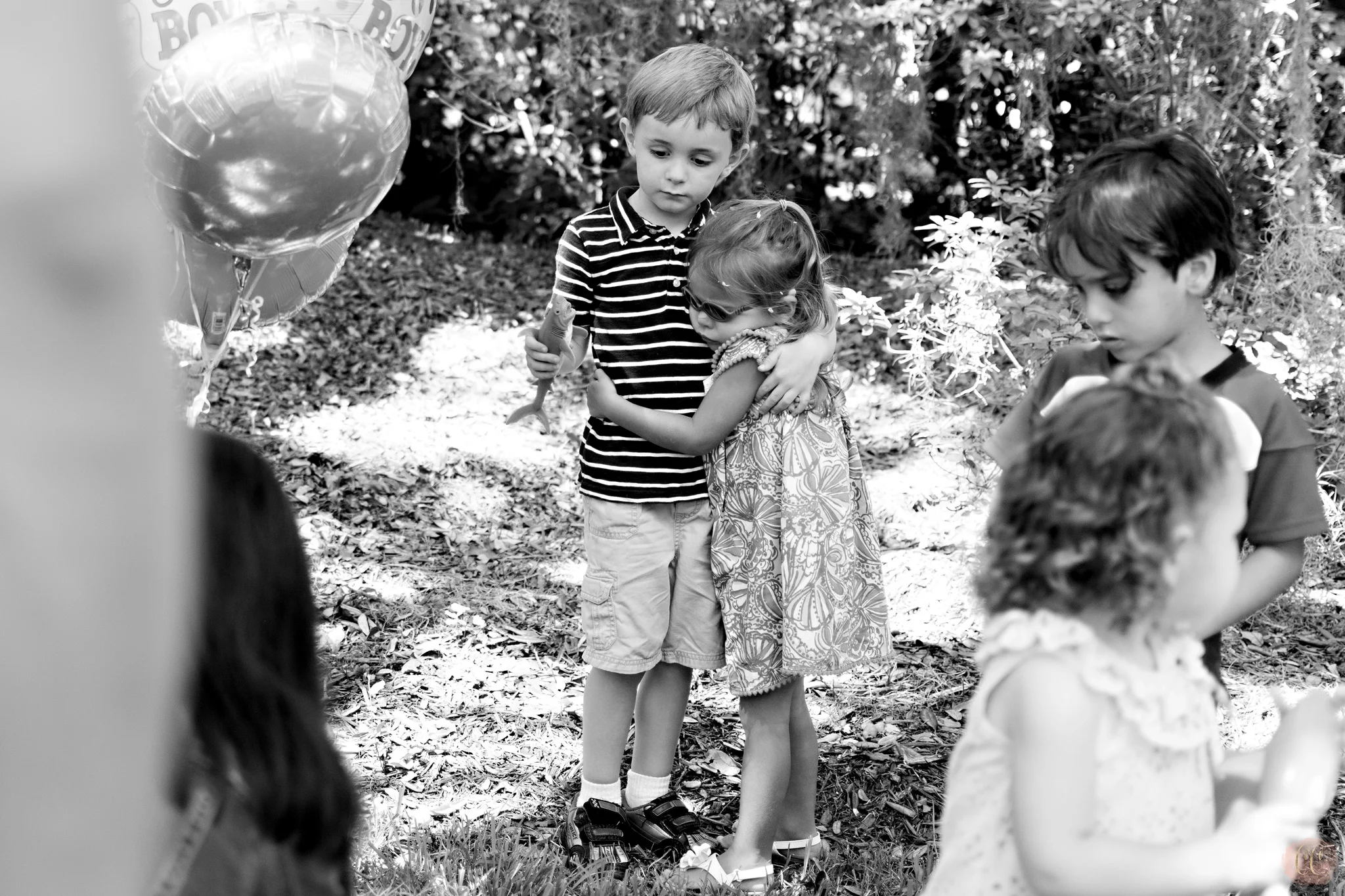 Children that are best friends hug at gender reveal party at The Tampa Yacht Club, picture taken by Carlie Chew Photography 