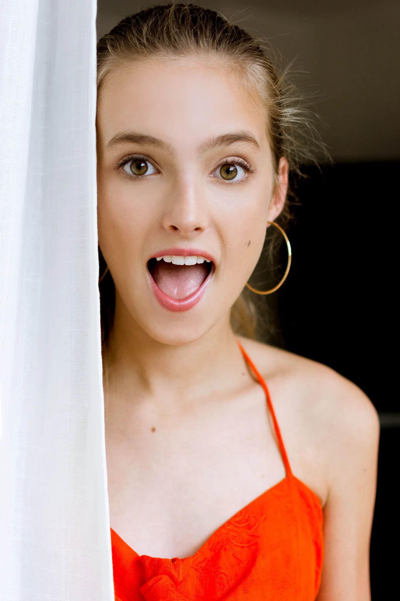 Model poses with surprised face in red jumpsuit, headshot photographer Carlie Chew Tampa, Florida 