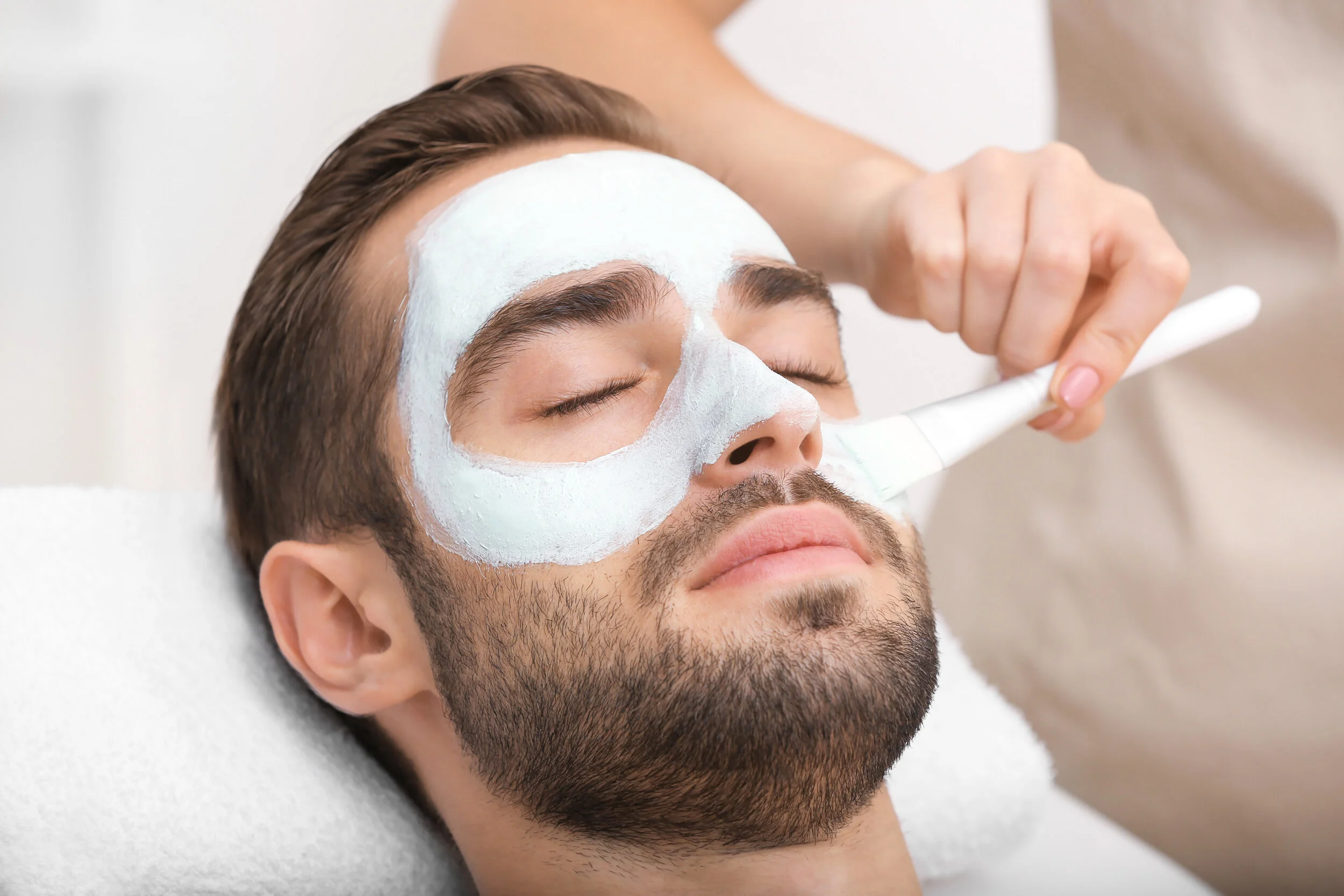 Man having cosmetic mask in spa salon