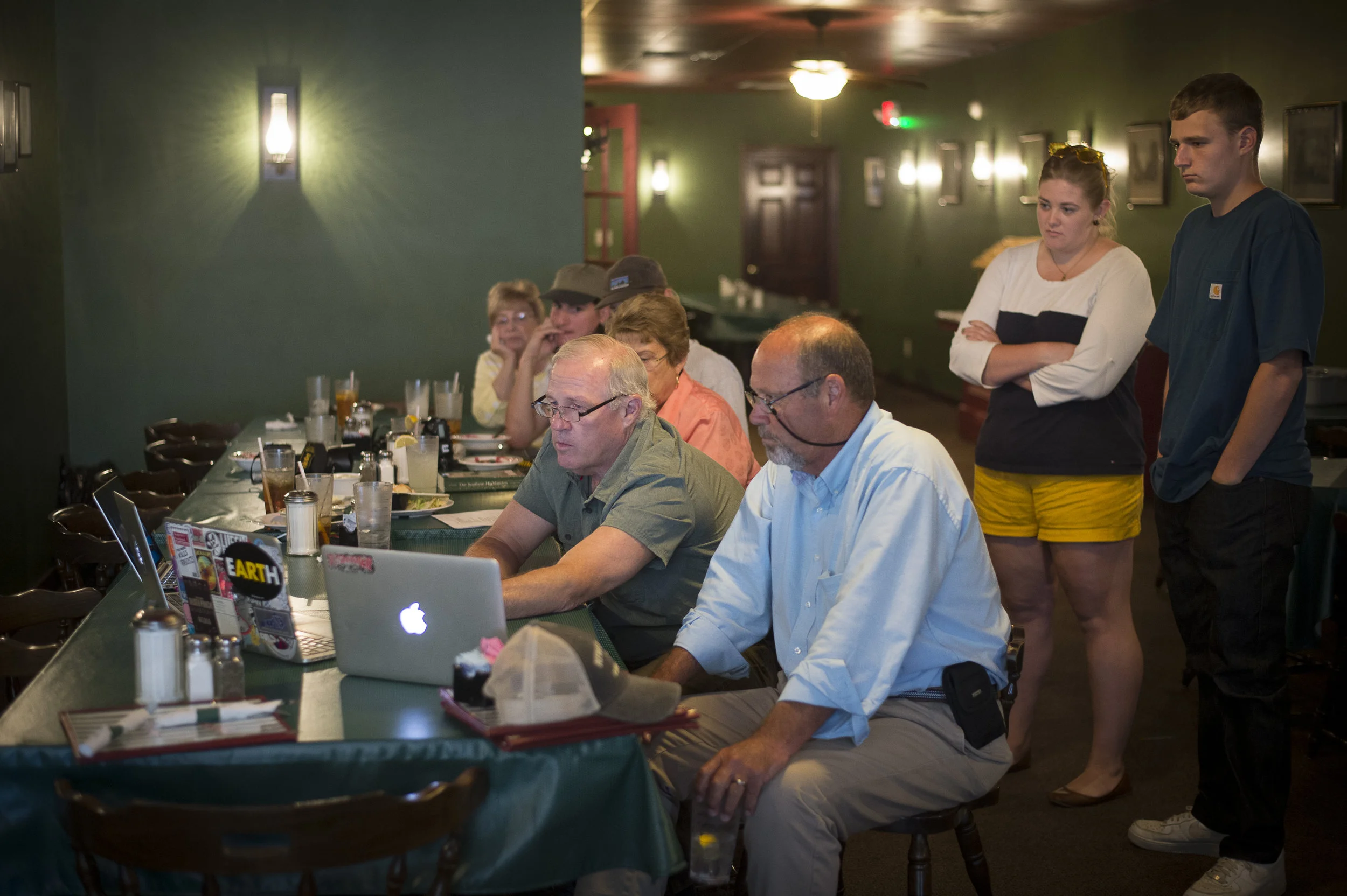 Gary Landers and Charles Bertram (along with Michael Keating not shown here due to his documentary instincts taking over in making this photograph) judge the photo essays submitted during the Boyd's Station Dawn to Dusk Photo Challenge.