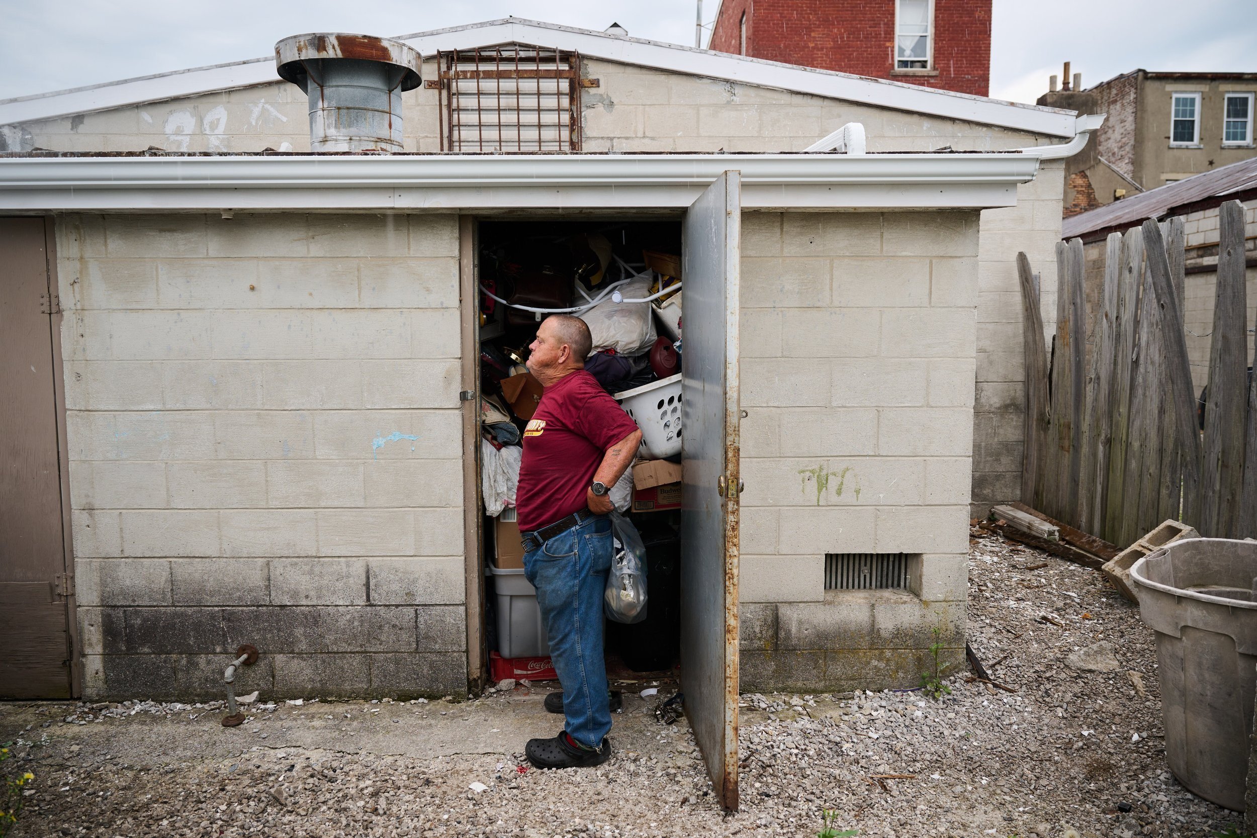  7/8/23—Cynthiana, Kentucky — Fryman puts his belt back on after determining he has no more room in his storage locker. He wraps his keys around his belt loop to ensure he doesn’t lose them while bending over to pick up items along the road or in the