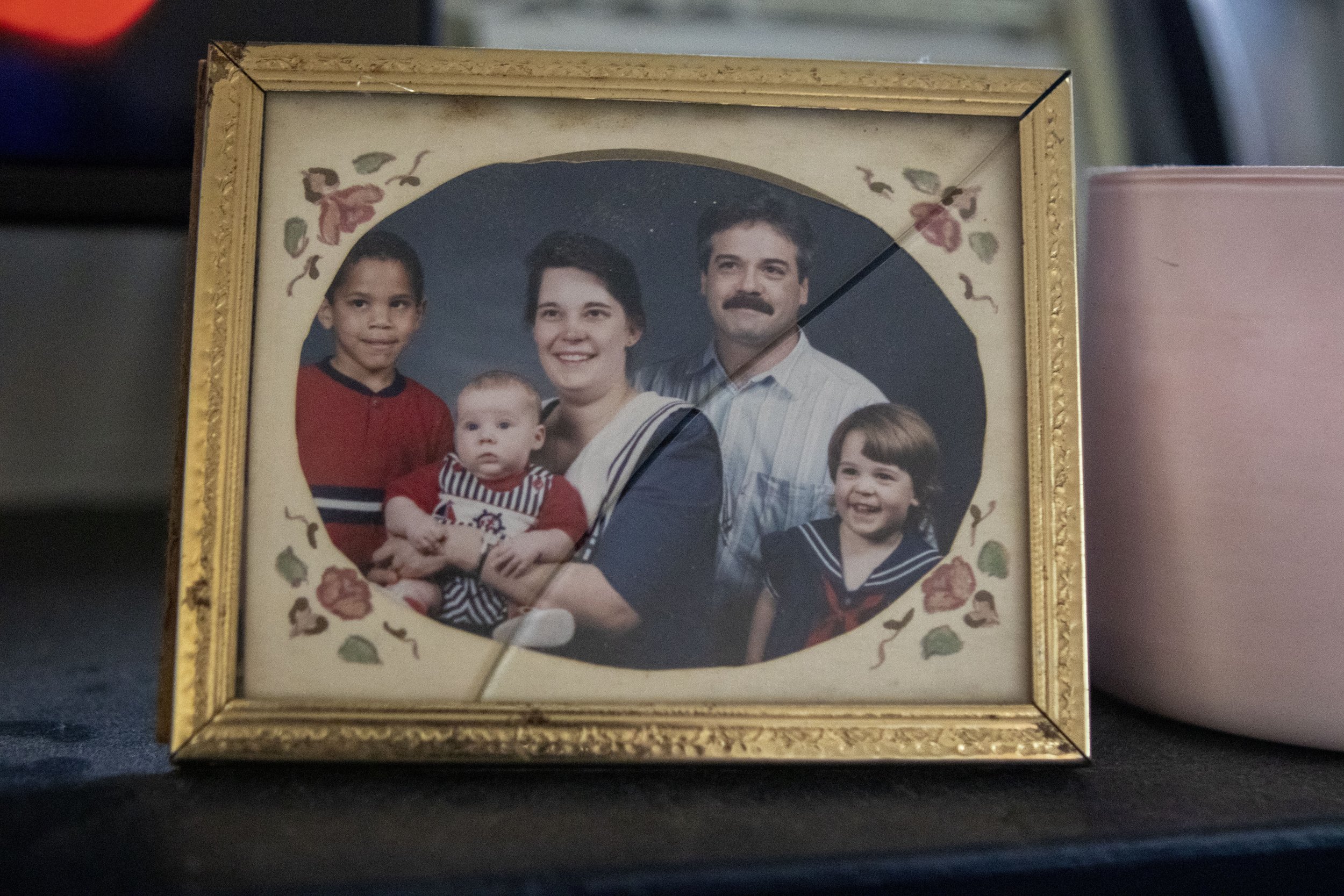  Left to right, a family portrait of Joshua Moss, Joseph Moss, Kay Moss, David Moss, and Breanna Moss, sits cracked on a mantel in the Moss family home. The house features many photos of the family, but are centered around Kay. 