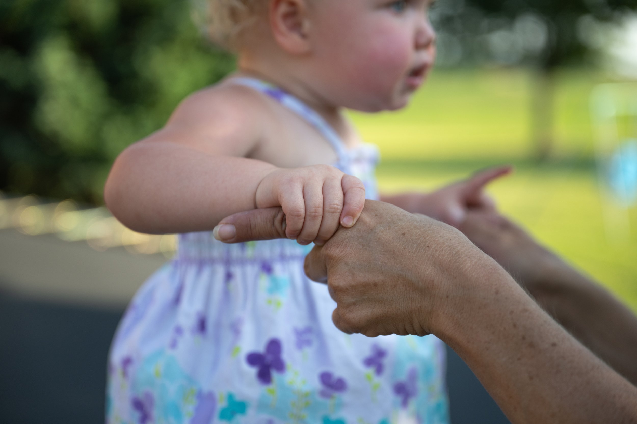  7/7/23 -- Cynthiana, Kentucky —  Emberly Sumpter, left, 1, holds her grandmother  Nicole McNees's hand for support as Sumpter jumps on the trampoline at McNees' home in Cynthiana, KY on July 7, 2023. 
