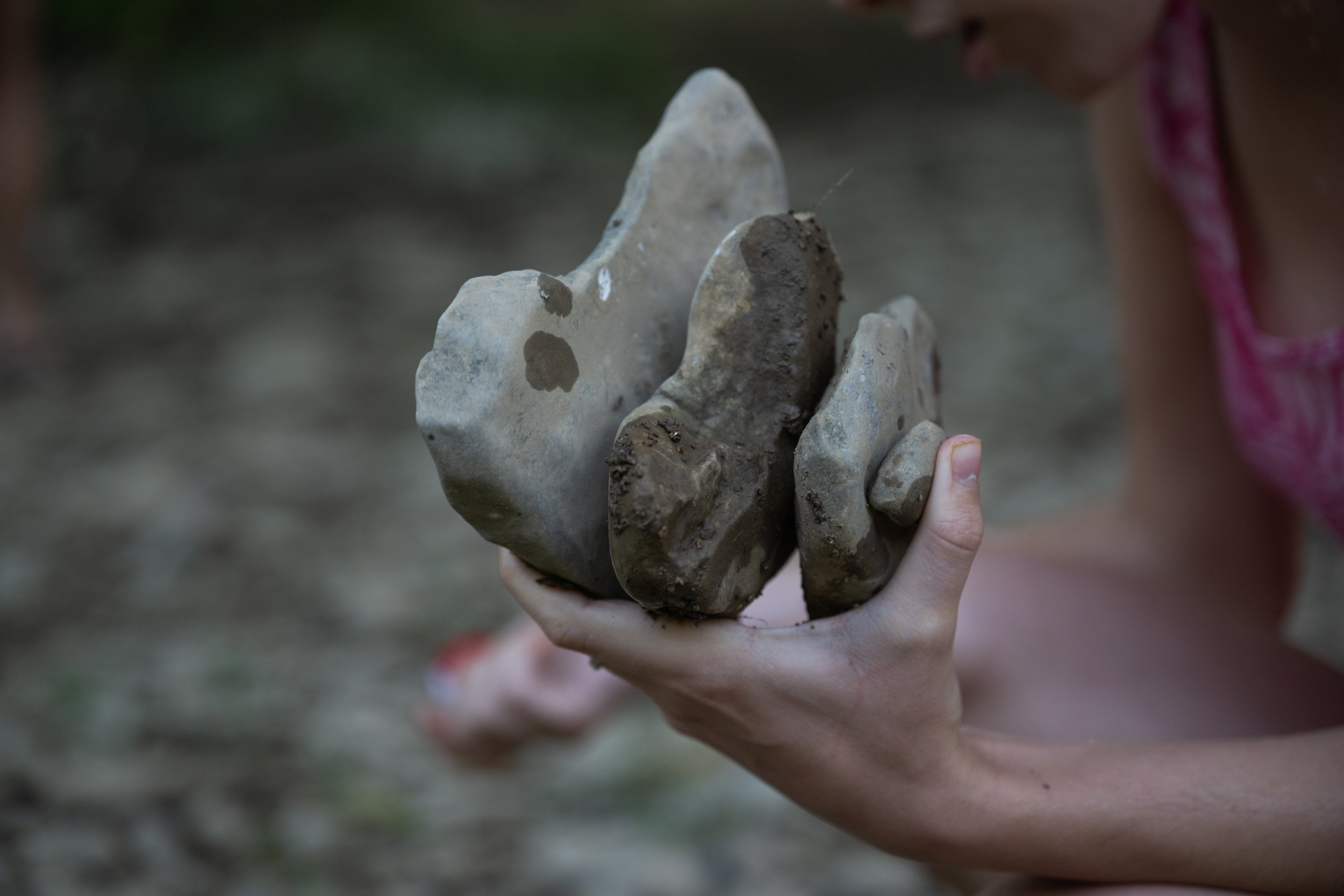 7/7/23 -- Cynthiana, Kentucky —  Ashlynn McNees, 18, holds a stack of heart-shaped rocks in her hand by the South Fork Licking River in Cynthiana, KY on July 7, 2023. 