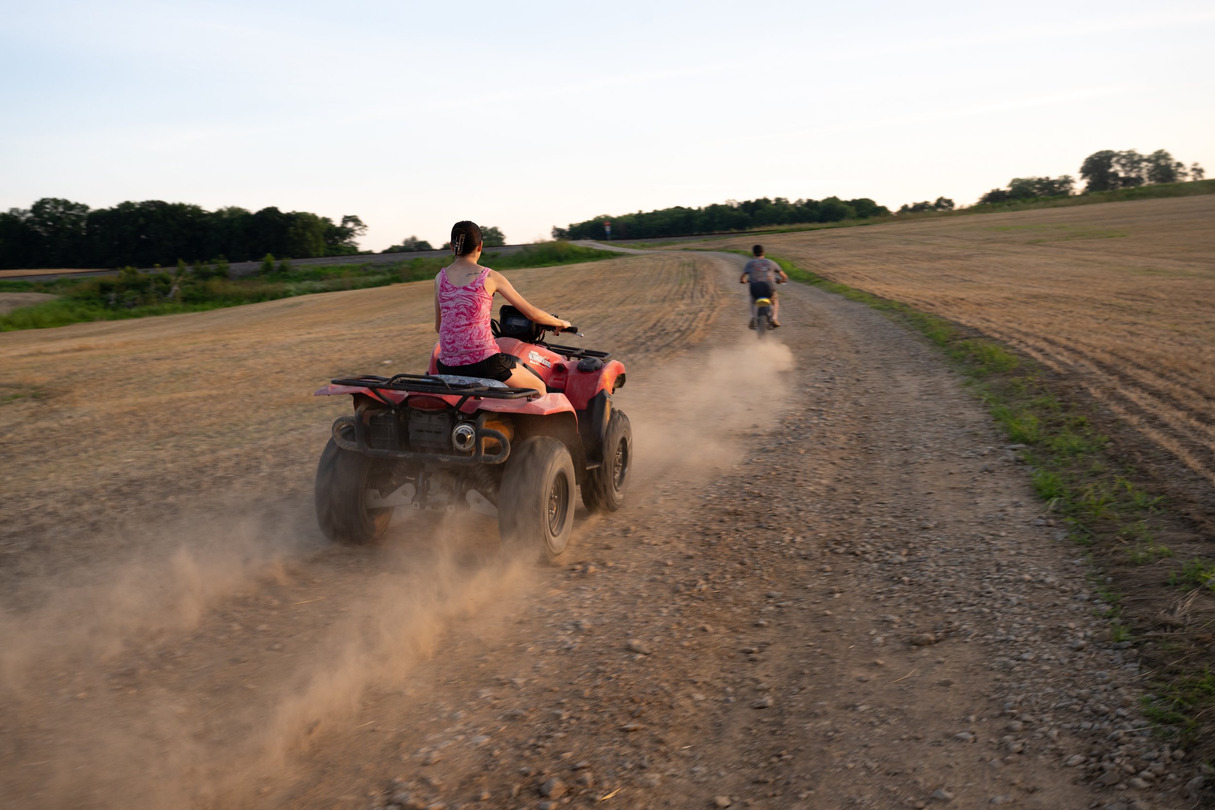  7/7/23 -- Cynthiana, Kentucky —  Ashlynn McNees, 18, rides a four wheeler on her family's land with her boyfriend, Chase Edwards, in Cynthiana, KY on July 7, 2023. 