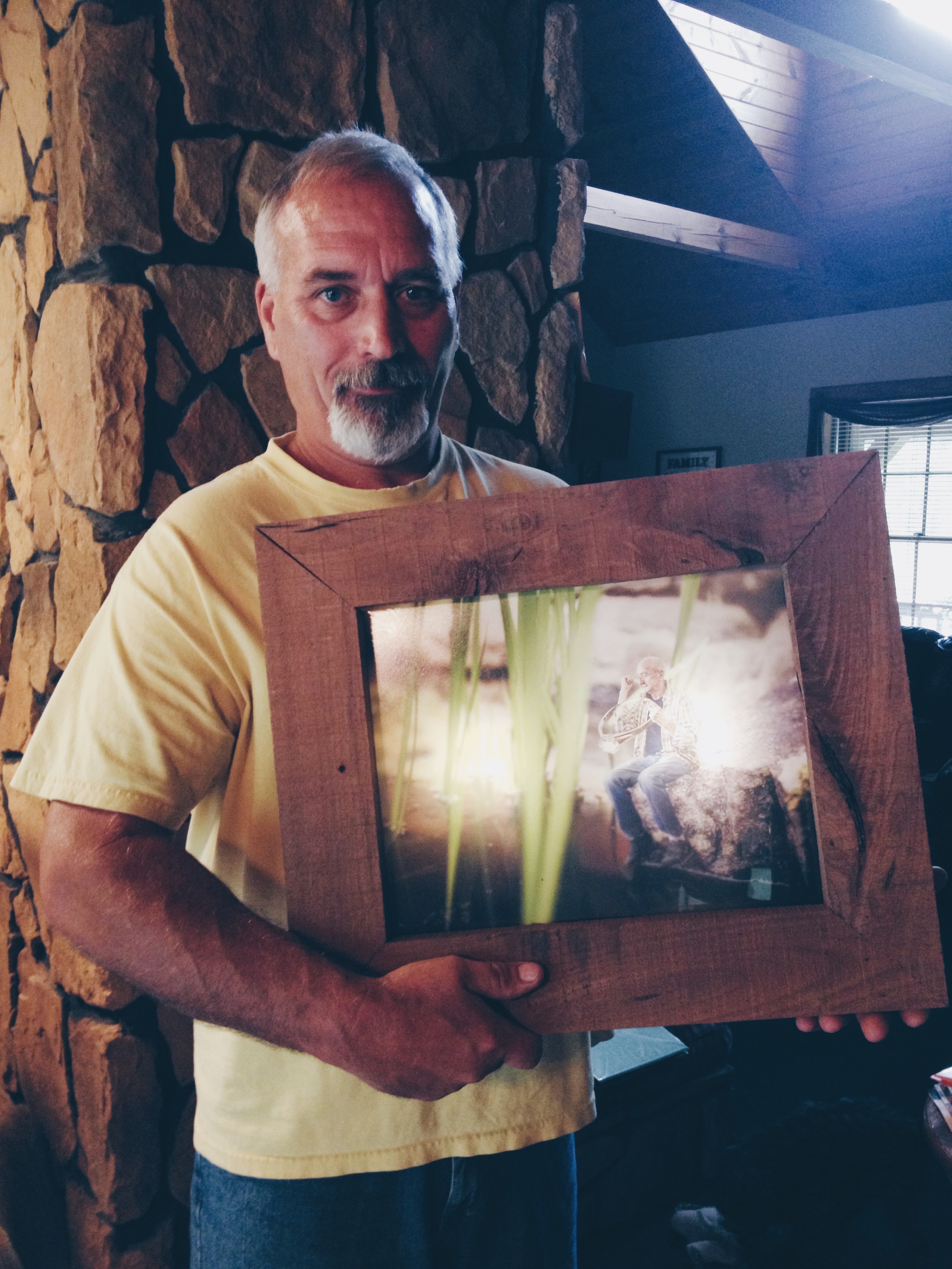 Dad holding the final product after a full week of work on the five frames we designed and he built from scratch.