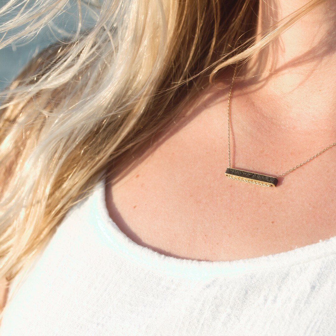 Life is a highway...🛣️⁠
⁠
Our eco-friendly Superhighway Bar necklace carries a little secret...it's inlayed with black highway repair material, which happens to be water-safe and quite durable. ⁠
⁠
The finished texture is very similar to asphalt and