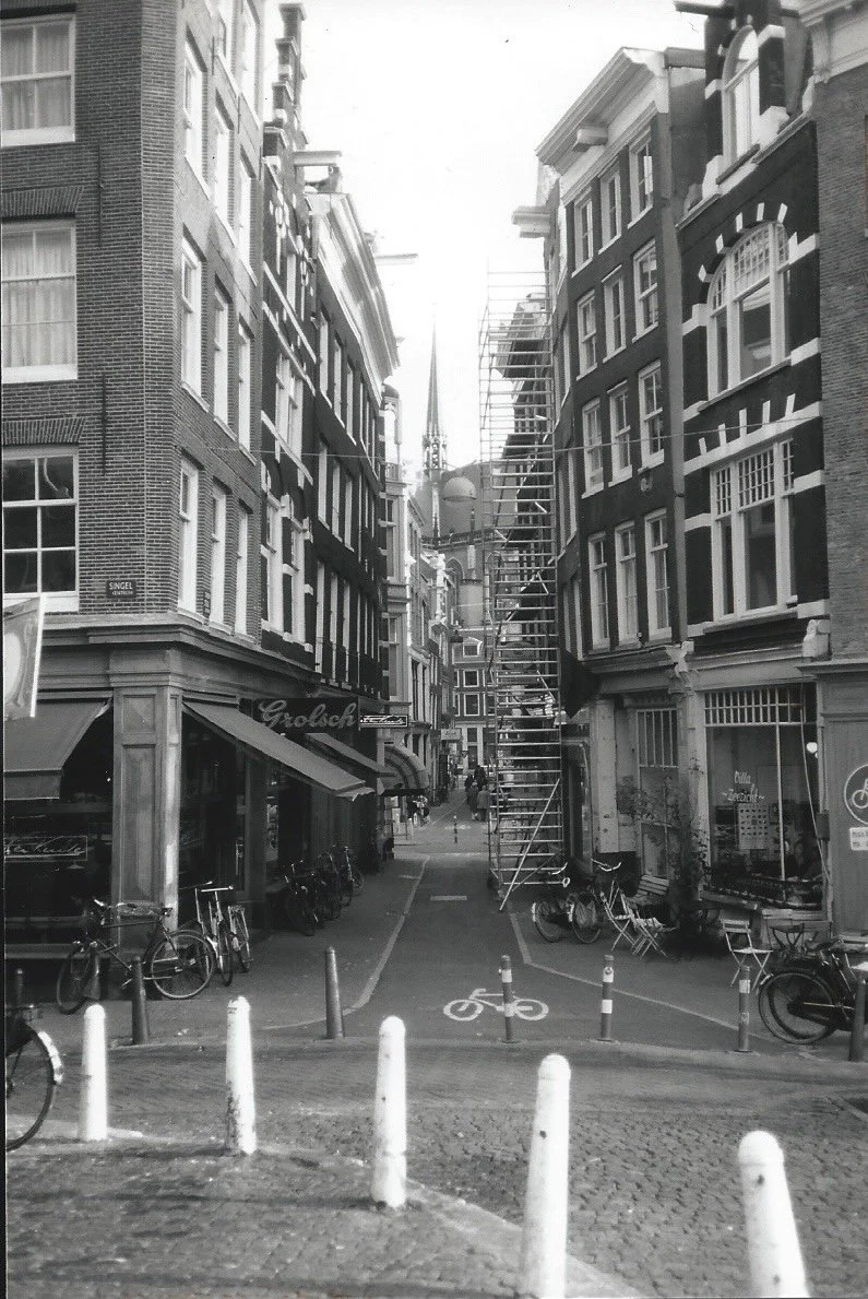 Amsterdam Stroll: Wandering aimlessly down a quiet street, I let the city’s narrow facades and gentle rhythms wash over me—a small, perfect moment of discovery in Amsterdam.