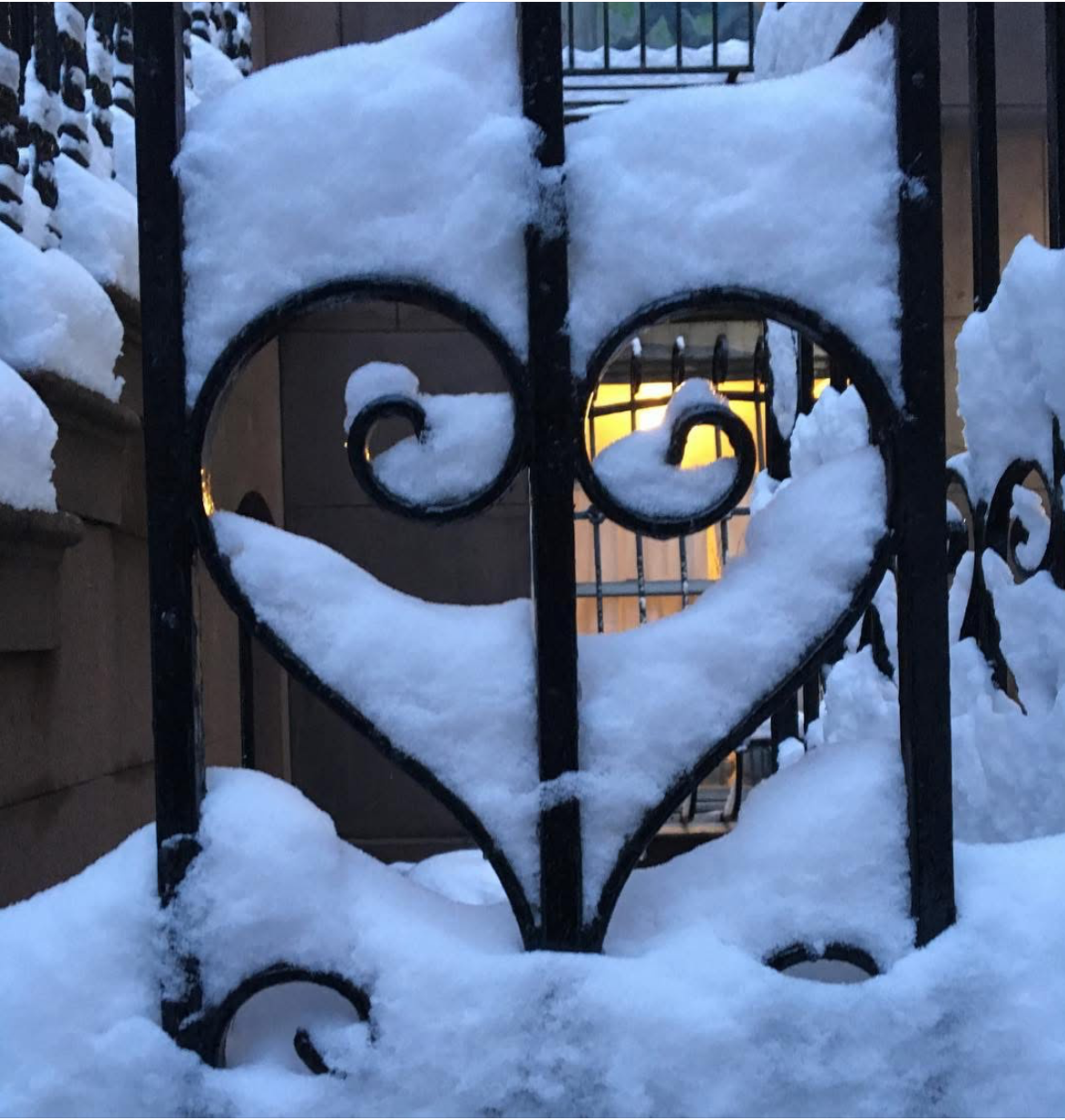 Winter’s Heart: A heart of snow on a wrought-iron gate, holding a soft glow of winter’s warmth.