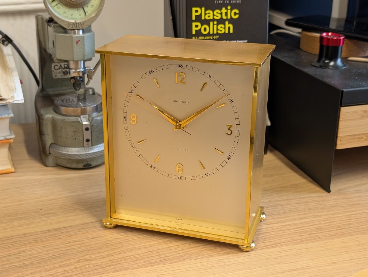 Garrard gold-cased mantle clock with silvered dial and Portescap electric clock movement