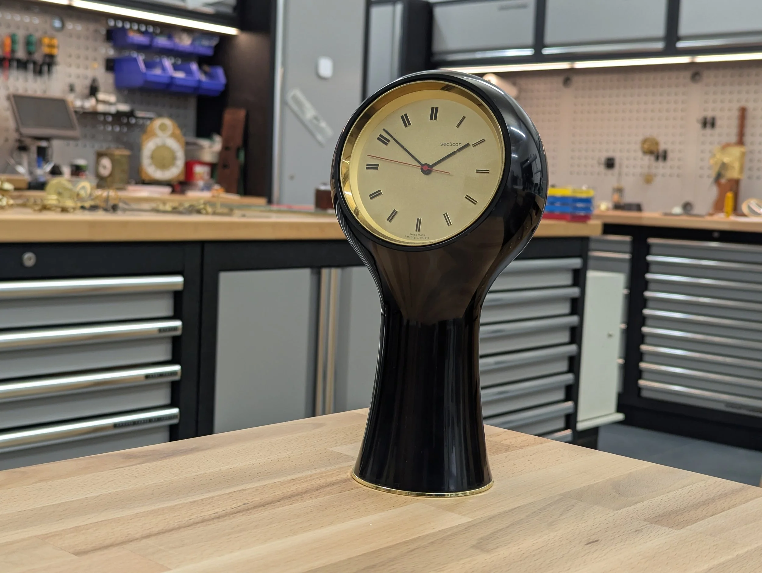 Secticon Clock designed by Angello Mangiarotti in black plastic with a Portescap electric clock movement