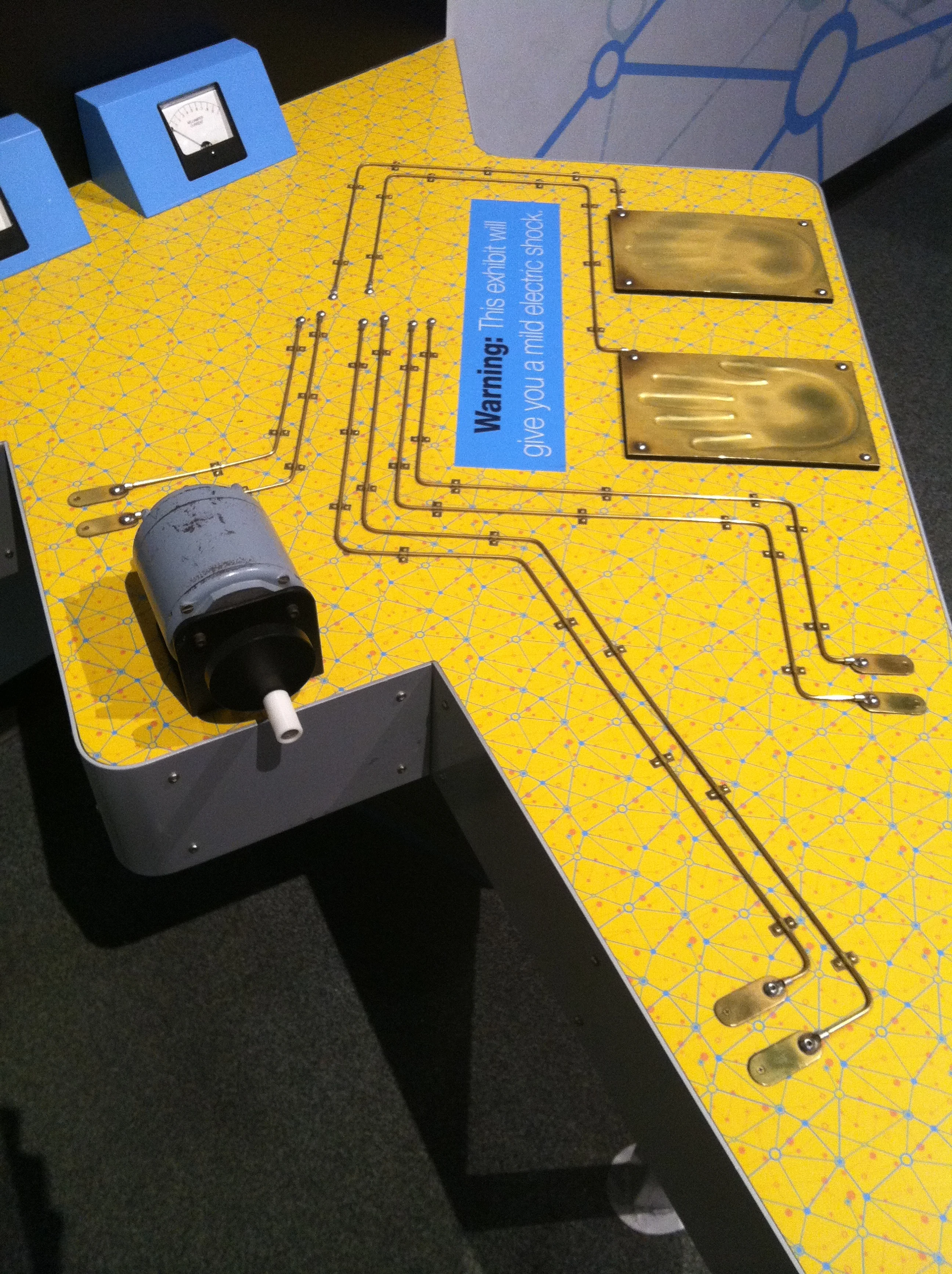 I also visited COSI for the first time recently. This particular exhibit allows you to safely feel an electric current. There might be some value in this.