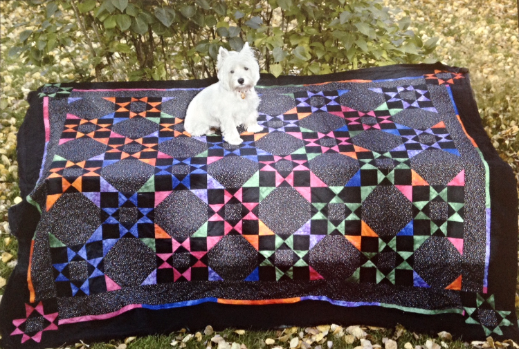One of Kathy Issacson's quilts from the good old days in Killarney and her Westie, Spike.