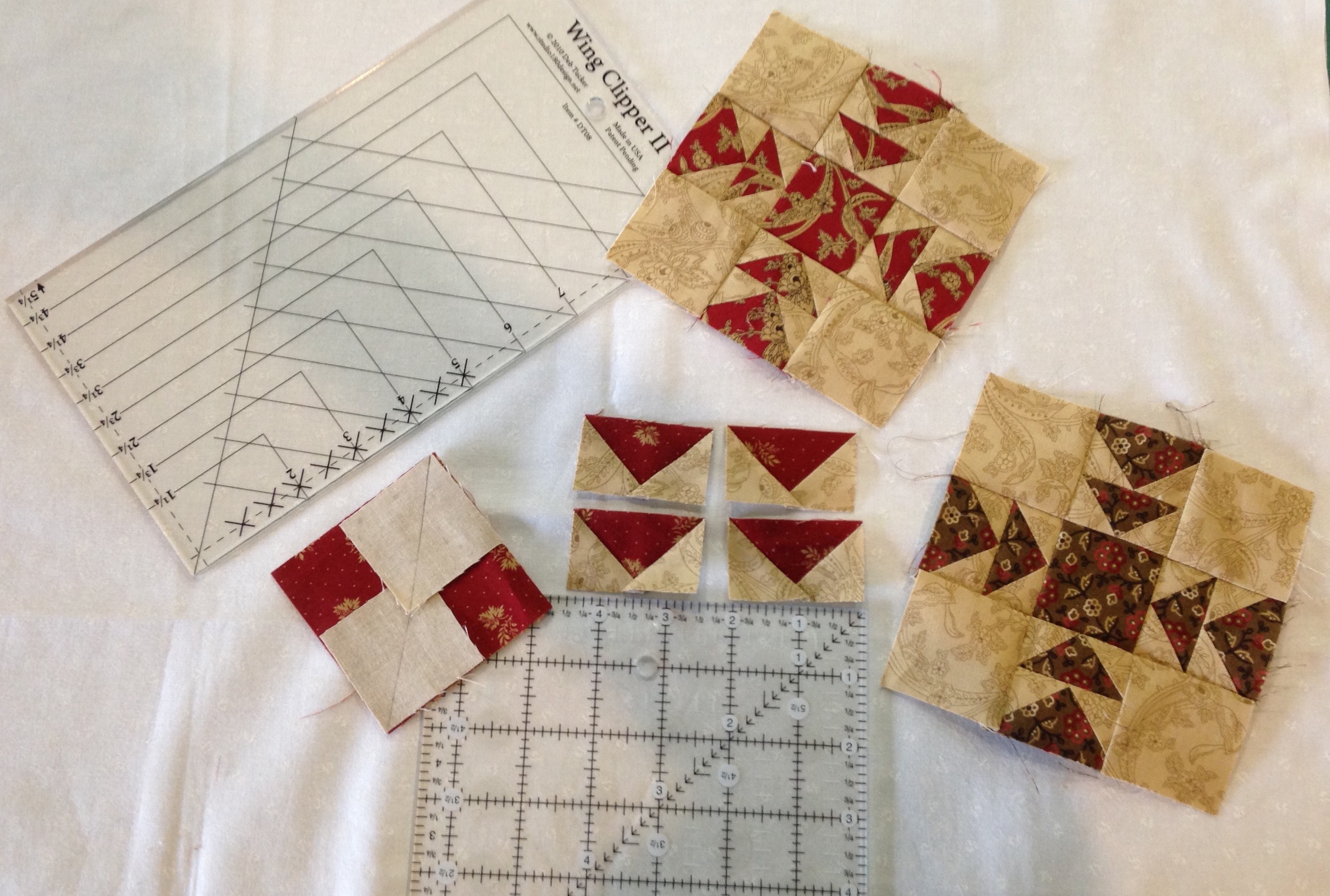 Flying geese units squared to 1 1/4" x 2" using the Wing Clipper 11 tool.