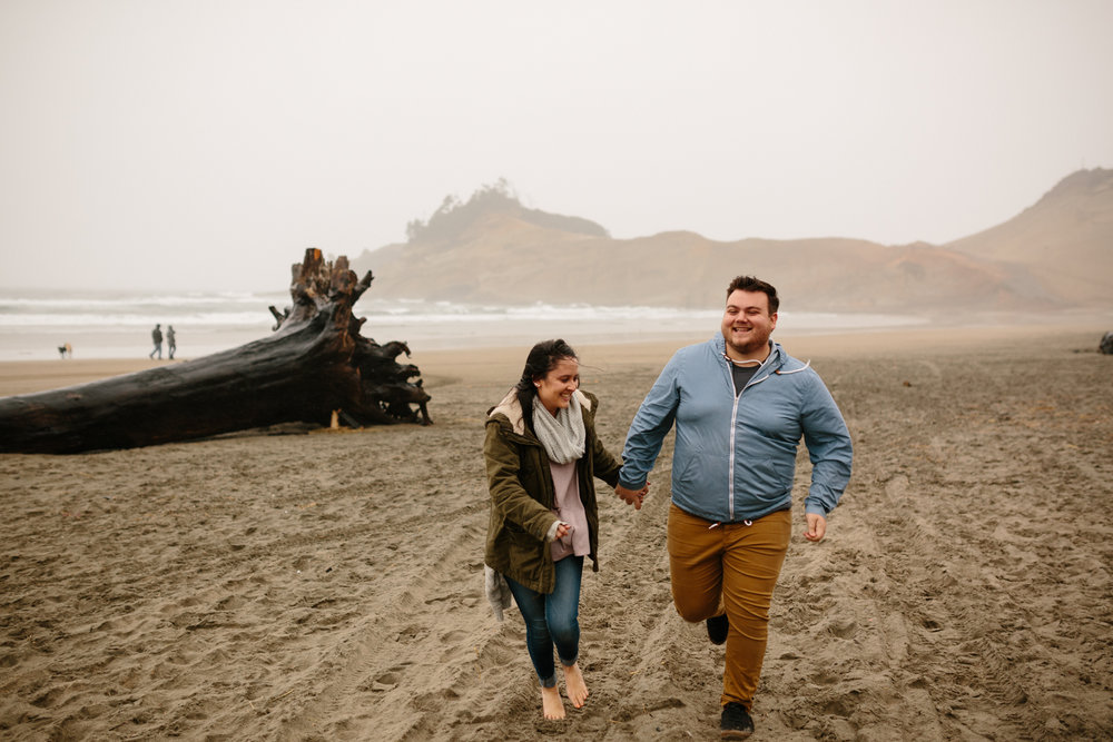 Couple running and laughing on the beach