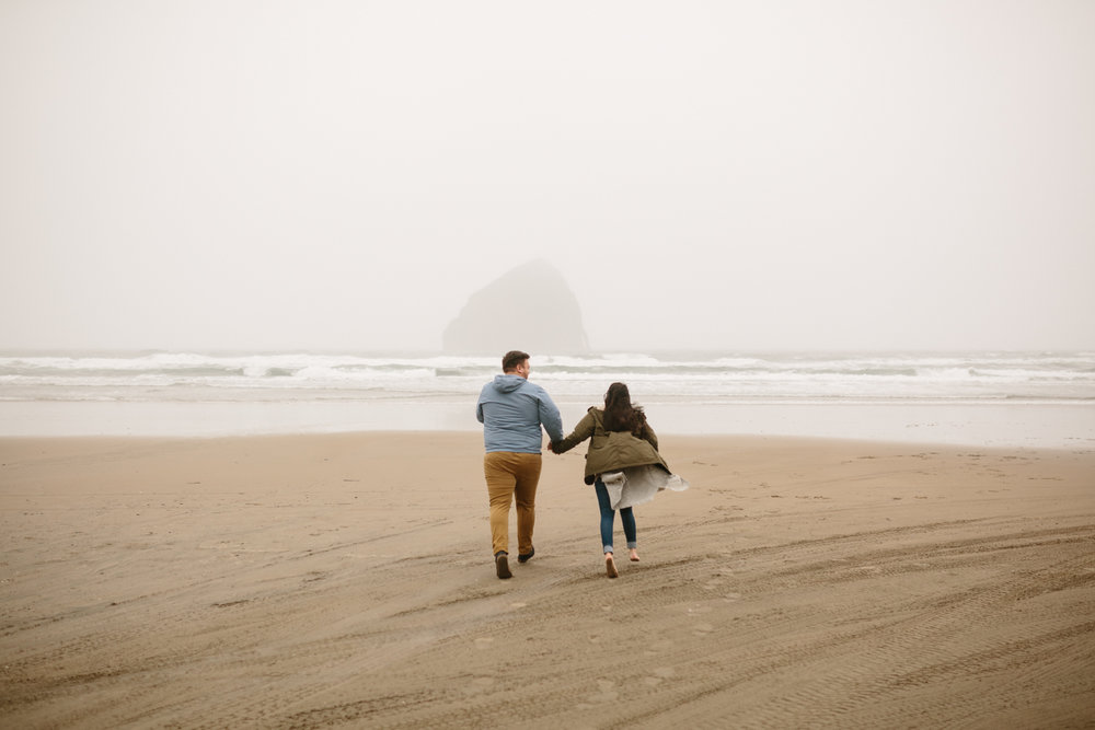 Couple running and laughing on the beach