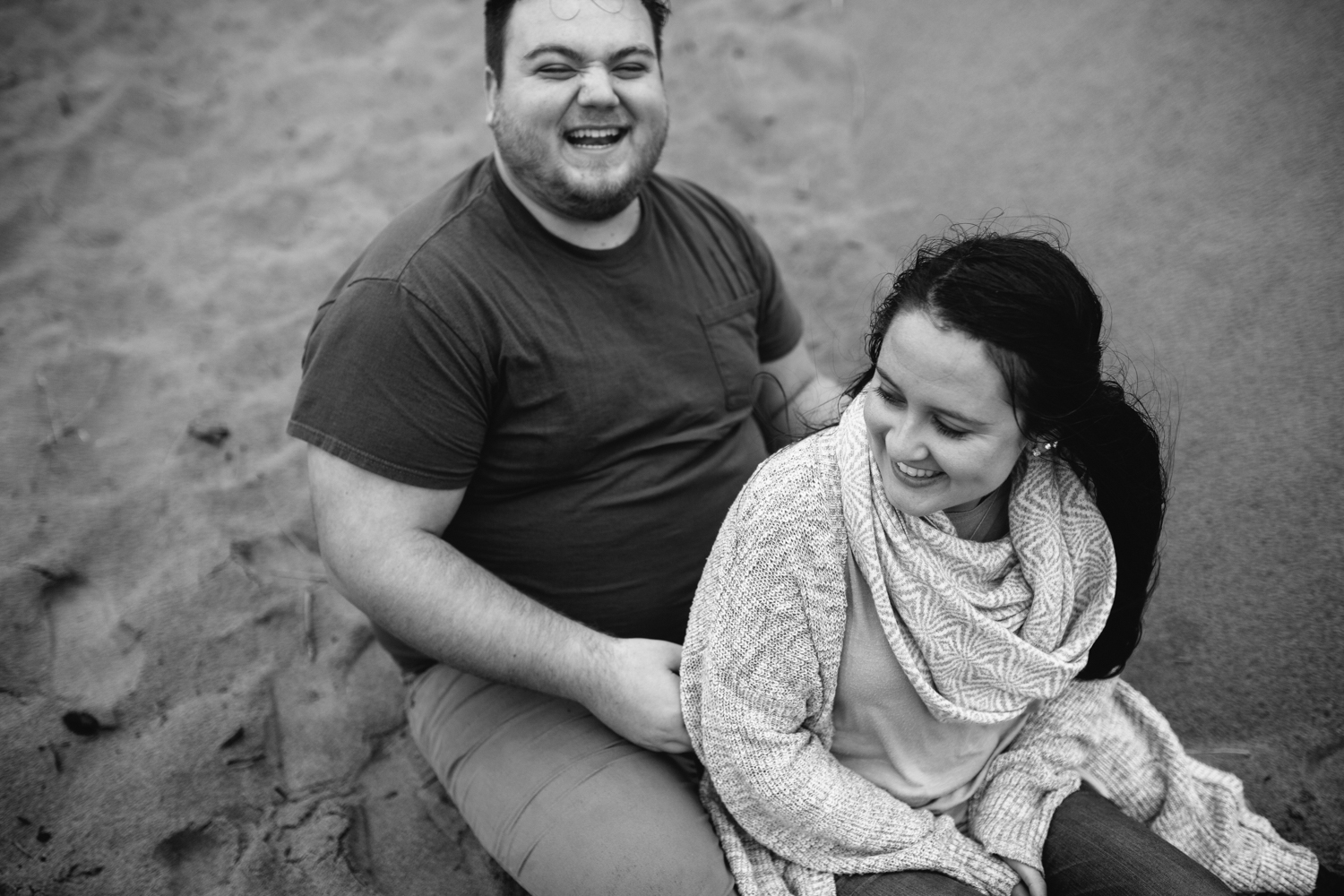 A happy couple cuddling on the sand
