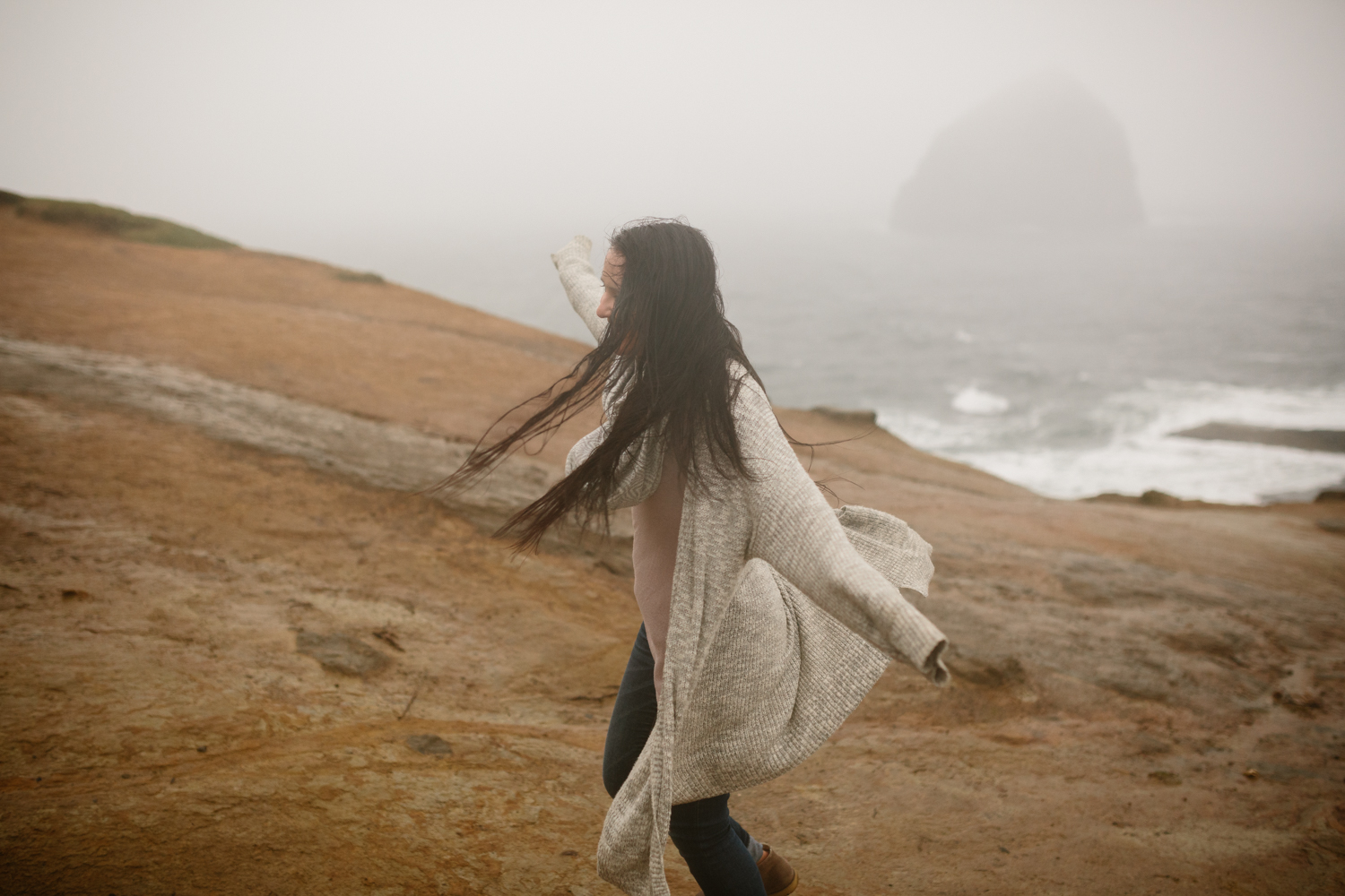 A portrait of young woman with wind blowing through her hair and