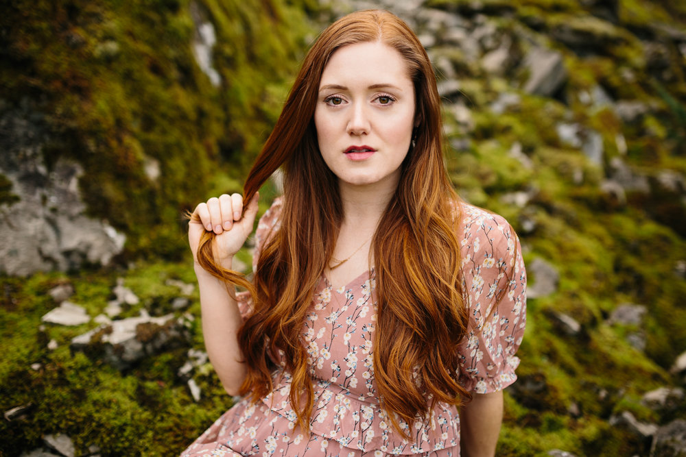 A stunning portrait of a red-haired woman staring at you