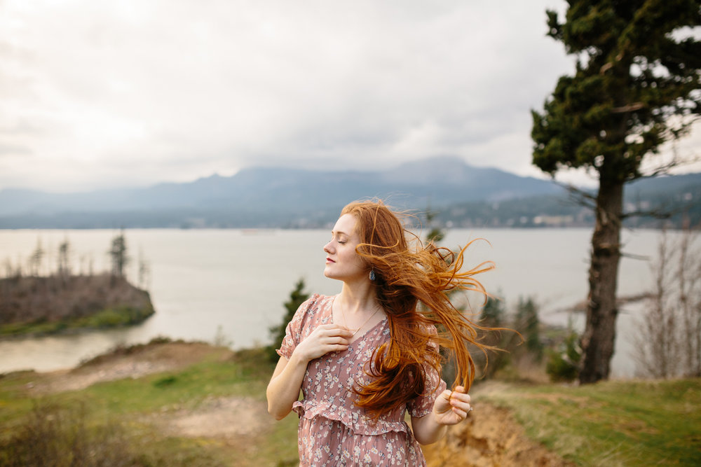 A Woman Letting the Wind Blow Hair From Her Face and Through Her