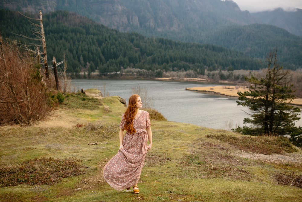 A Beautiful, Red-Haired Pregnant Woman Walking on a Windy Day in