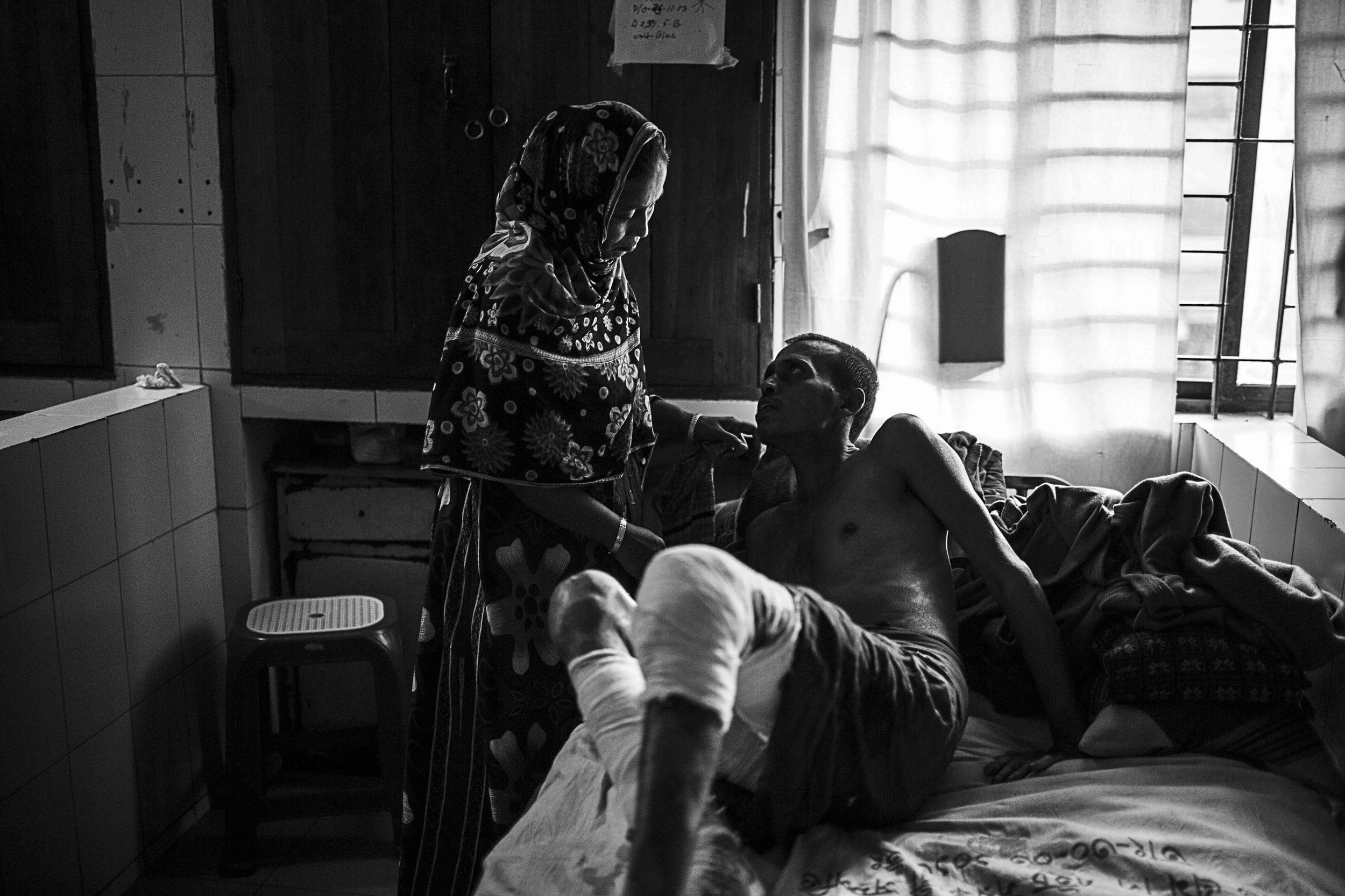  Mohammad Rubel Mia and Nasima Begum share an intimate moment between the chaos of the Burns Unit. 