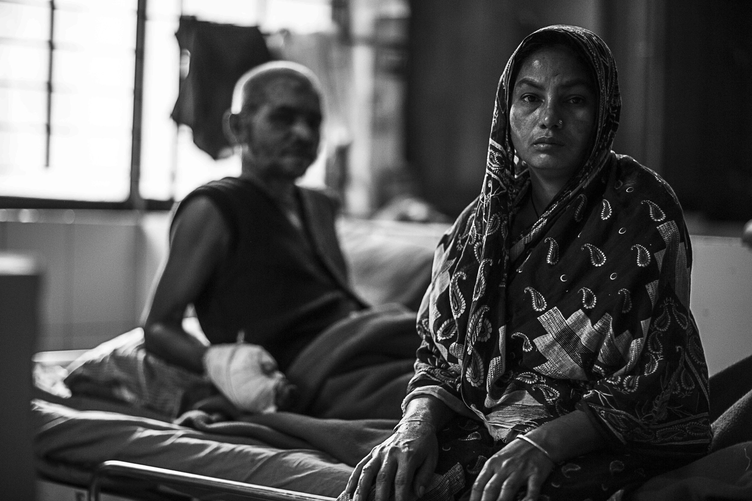  Sahira Khatun sits and waits patiently on her husband’s bed. Days are long within the walls of DMCH. 