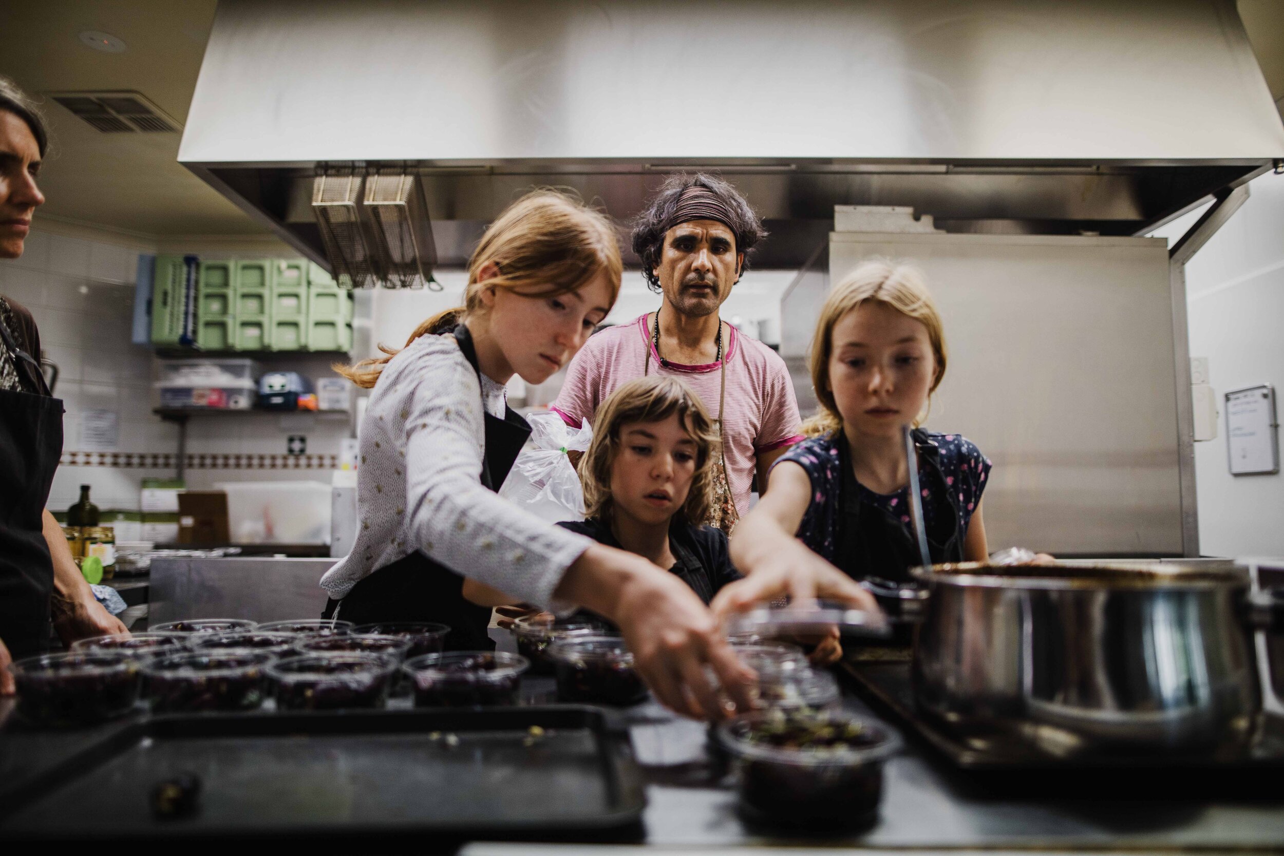  Arad with some friendly helpers in an industrial kitchen where he prepares for a busy weekend. 