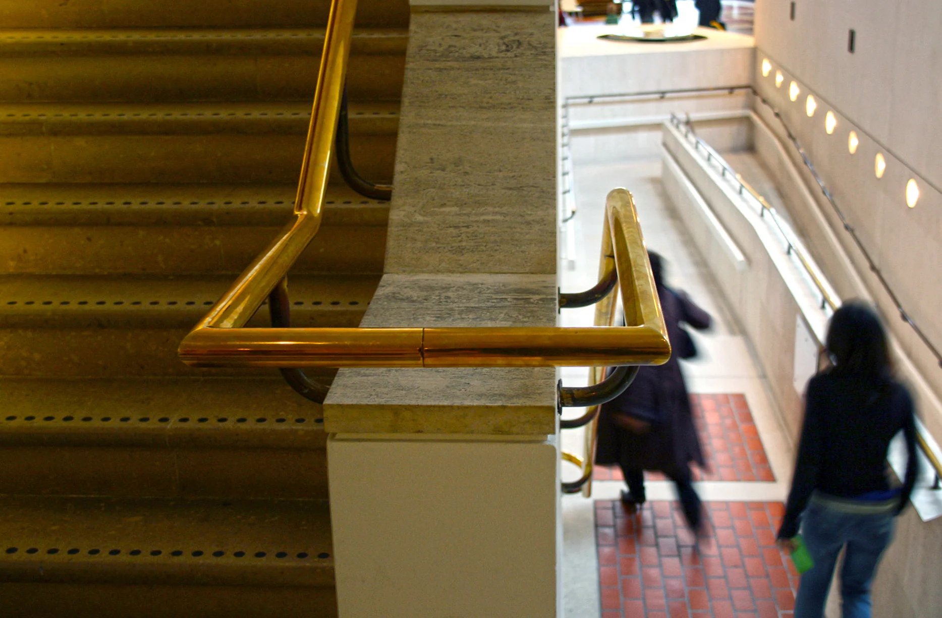 Brass handrails at the British Library in London. Note that this building predates current regulations regarding stairs, landings and ramps!