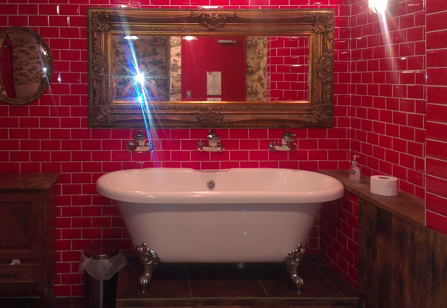 Claw-footed bathtub with three taps in Wembley pub. © Tamzin Doggart.