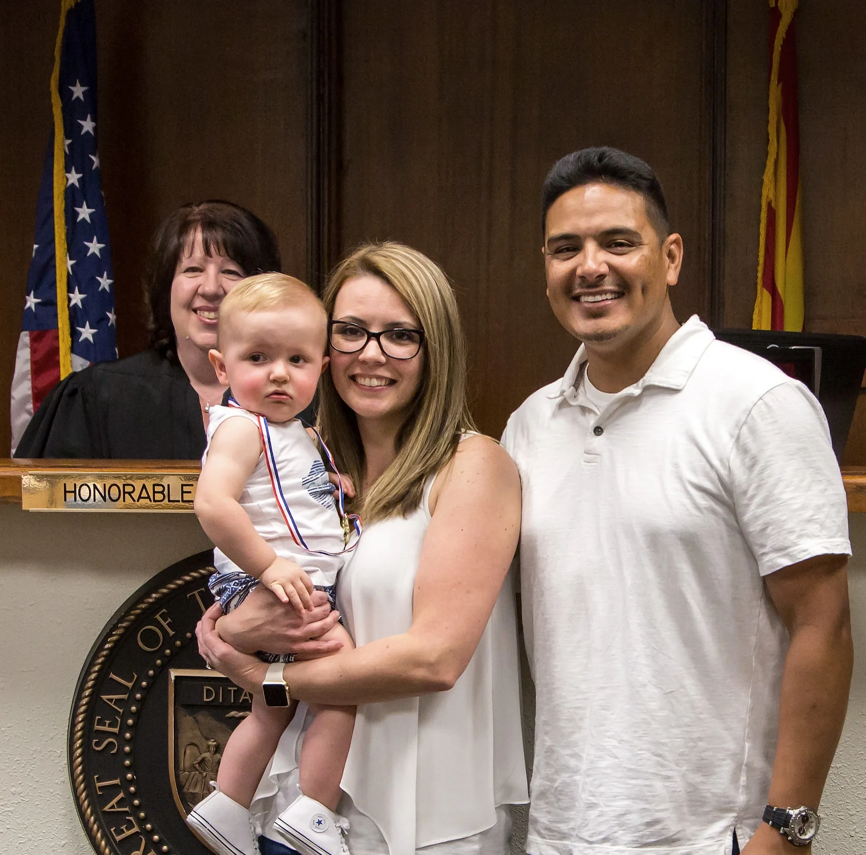 Ashley and Victor with Mason on his adoption day. 