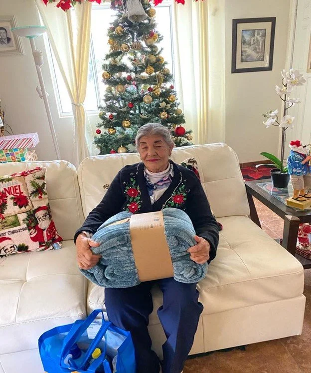 Older adult with Christmas gift