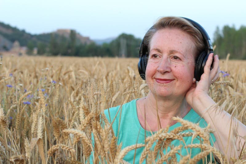beautiful-natural-mature-woman-headphones-outdoors-enjoying-music-copy-space-76706962.jpeg