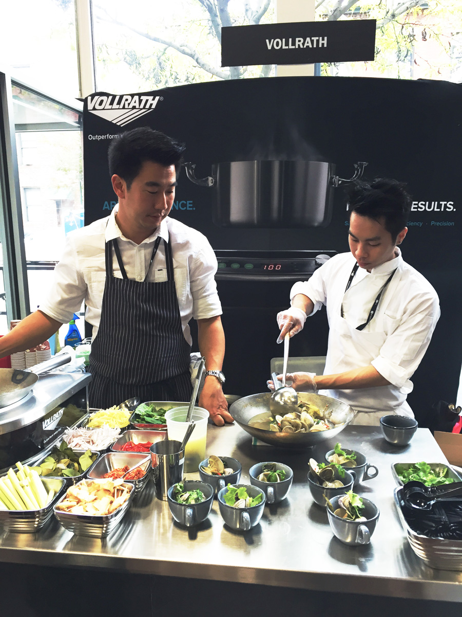 Angus An of Maenam , Vancouver doing a little clam stir-fry at the Vollrath booth.