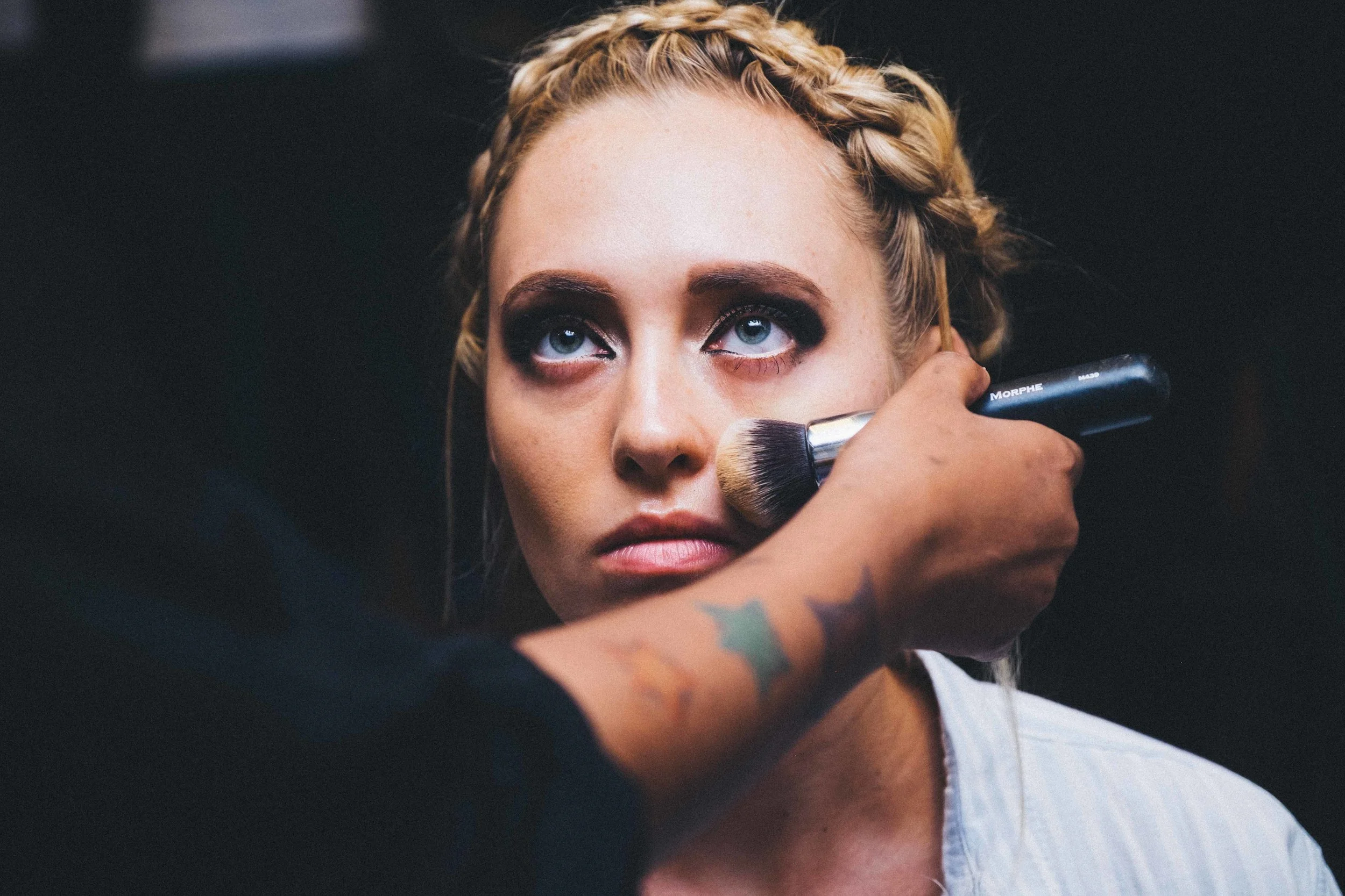 It looks as if she is looking at the face of God. But in actuality the makeup artist, so I guess there isn't really a difference.