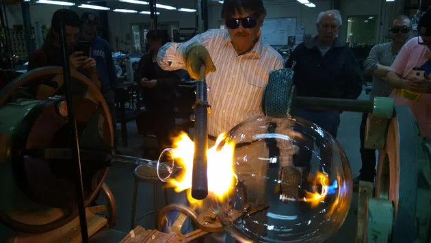 Instructor Dennis Briening demonstrating to the students on the lathe.