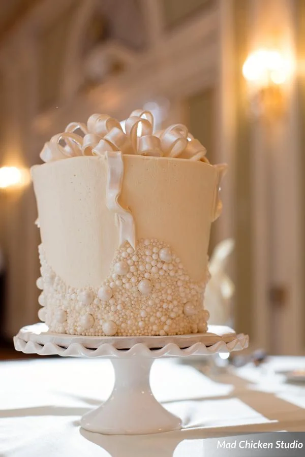 This wedding had one of the coolest cakes we have ever seen! We can forgive the fact that there weren't flowers on it ;) See more scrumptious goodies from How Sweet It Is Cakes here.