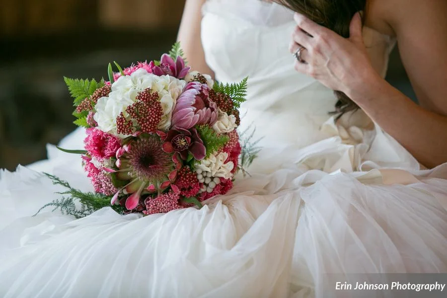 The bridal bouquet featured protea, white hydrangea, yarrow, silver brunia, tulips, lace fern, & plumosa - what a stunner!