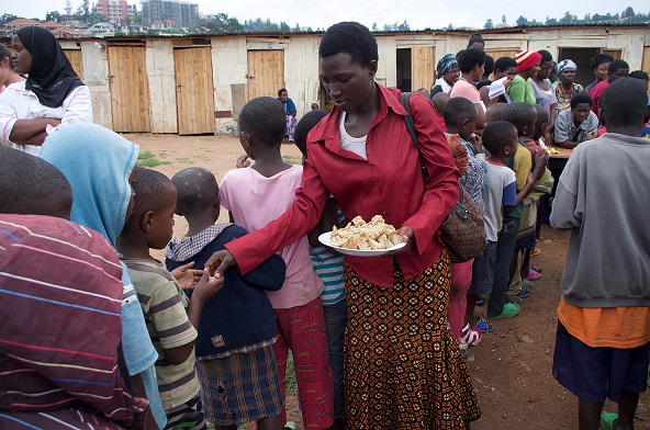  Community members gather around for a taste of TWB's banana soy bread recipe. 