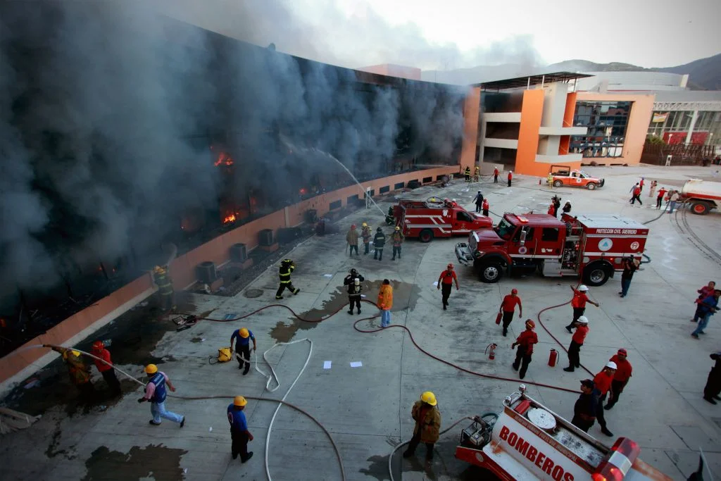 Protestors in Acapulco, Mexico set fire to a state capital building in response to the disappearance of 43 teachers linked to local drug cartels. Photo courtesy of Felix Marquez/AP. 