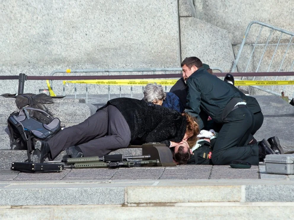 In Ottawa, Canada, an emergency response team attempts to resuscitate a security worker on the Parliament grounds following a shooting. Wayne Cuddington/Barcroft Media /Landov
