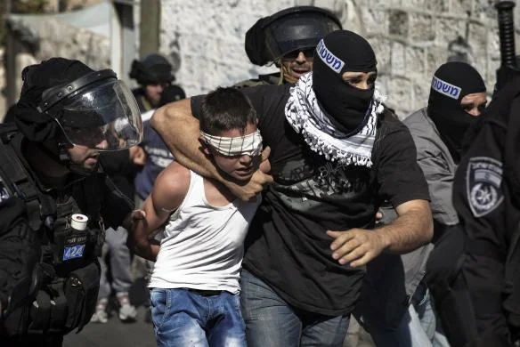 Israeli police apprehending a child following Friday prayers in East Jerusalem. REUTERS/Finbarr O'Reilly