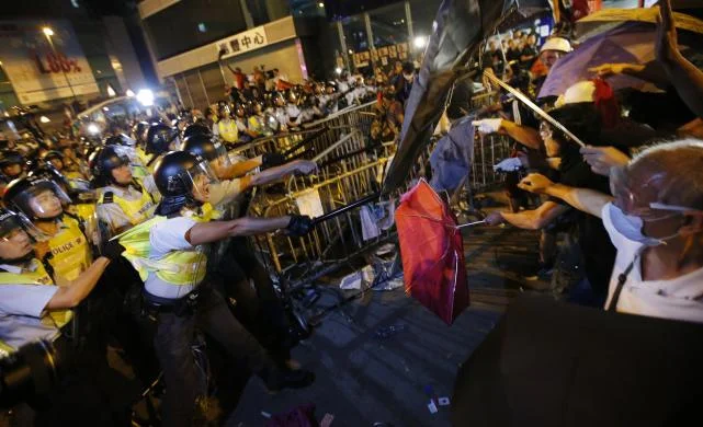 Police with riot shields warn pro-democracy protestors in Mongkok, Hong Kong, at a rally. REUTERS/Carlos Barria