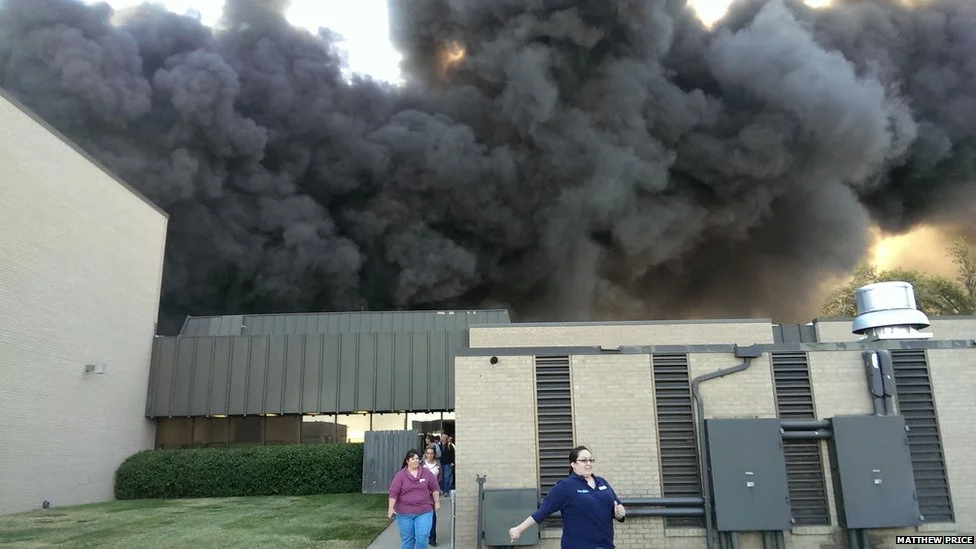 People hustle to exit the FlightSafetey International Building in Wichita, Kansas as a plane crashes on Thursday, killing four. Source: BBC