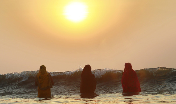 Hindu women pray as the sun sets over the Arabian Sea during the Chhath Puja festival in Mumbai, thanking the Sun God for sustaining life on Earth. Source: The AP