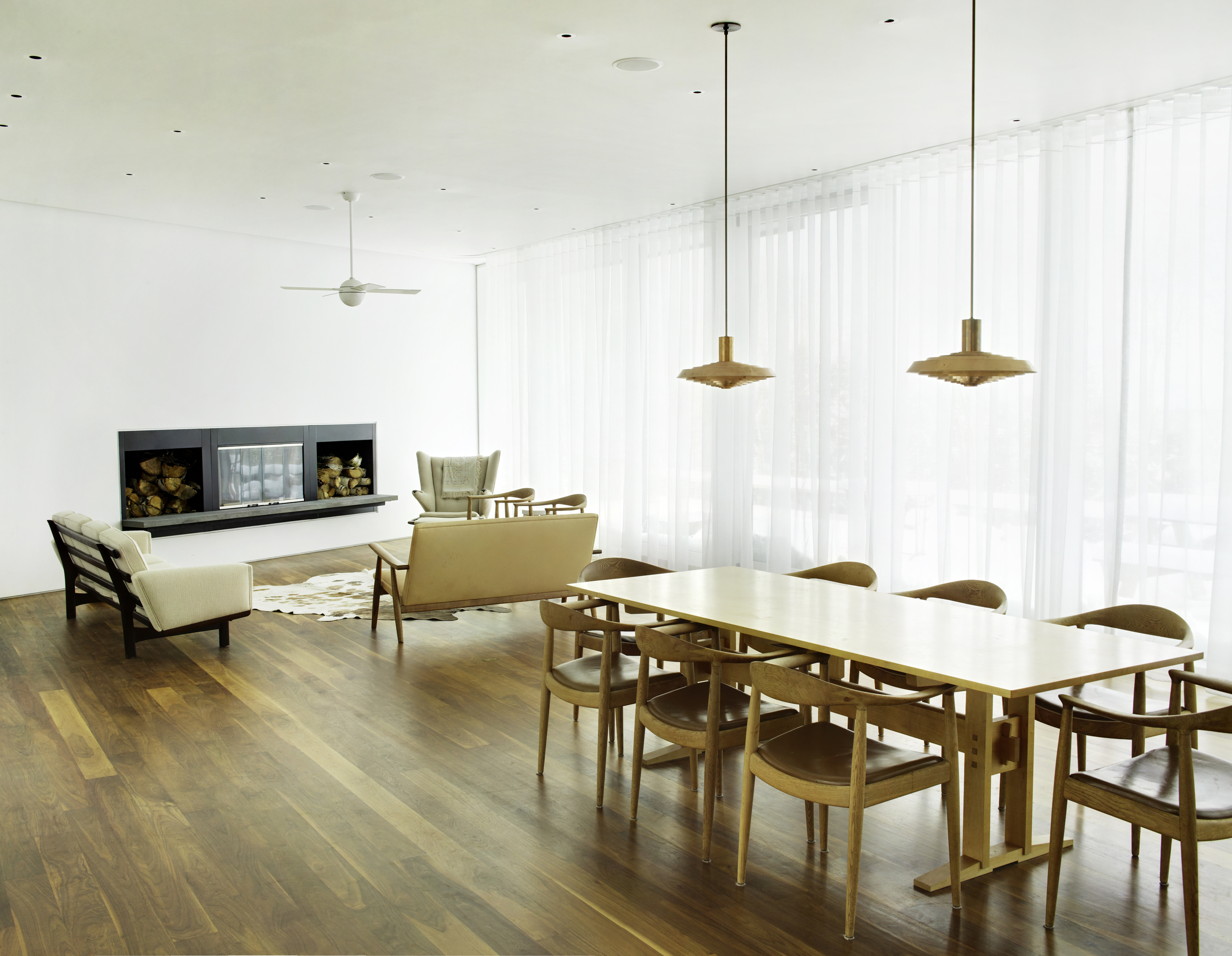 clean peaceful dining room with fireplace and pendant lighting bright